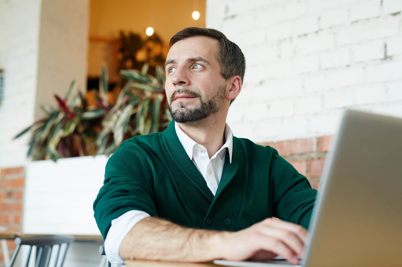 Thoughtful man working on laptop