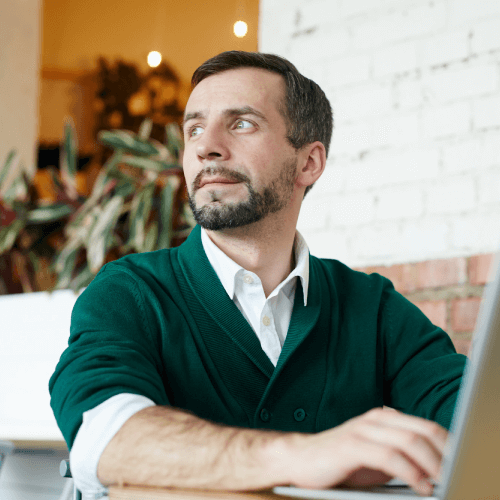Thoughtful man working on laptop