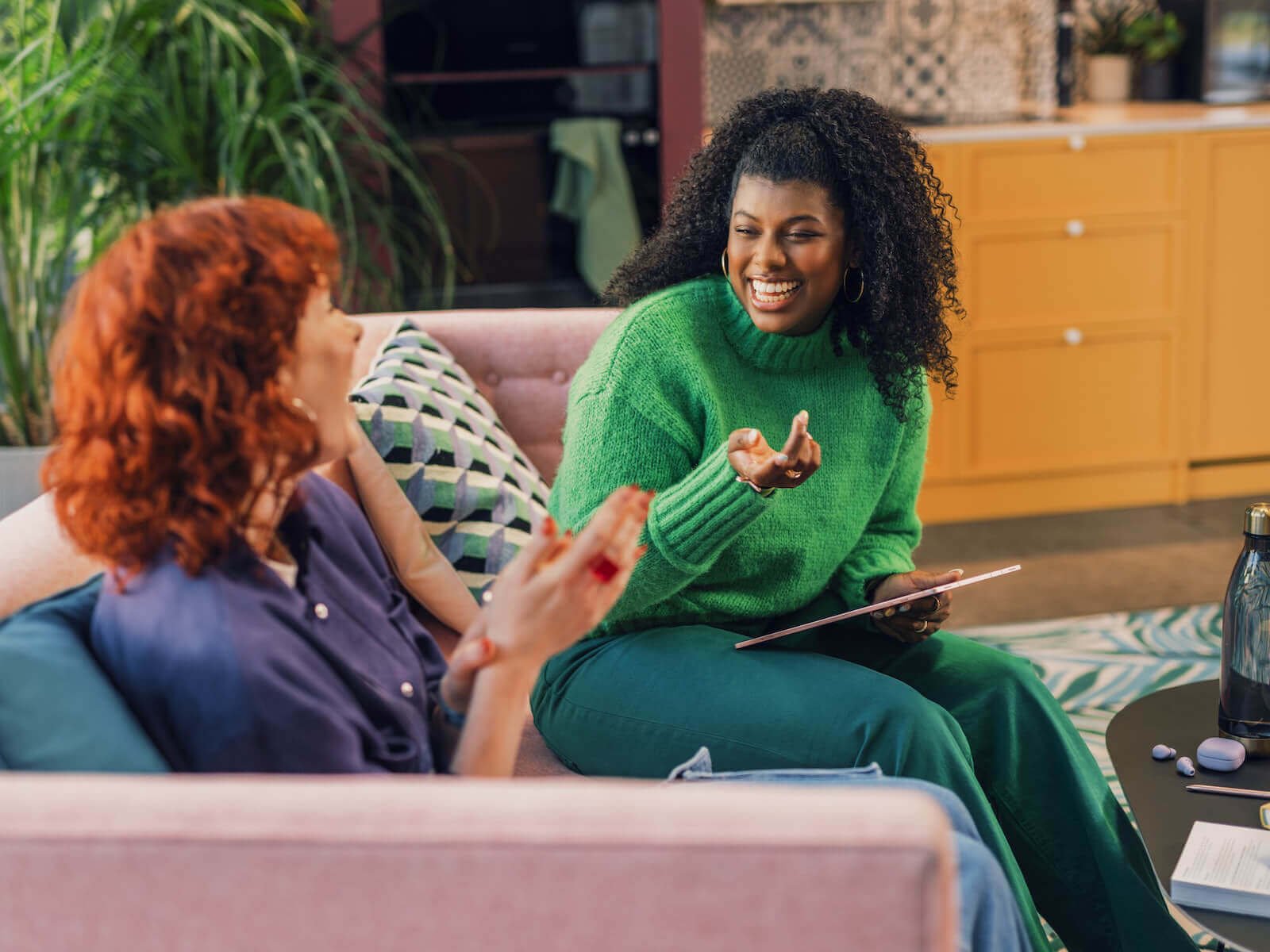 smiling women chatting on couch