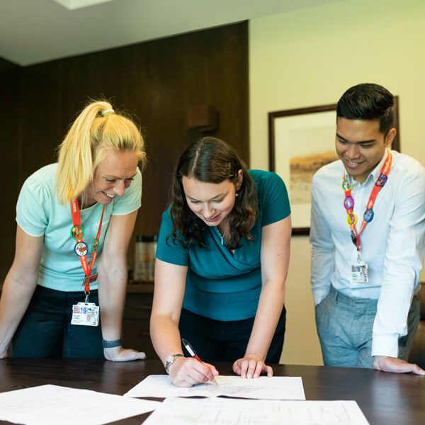 three colleagues reviewing a document