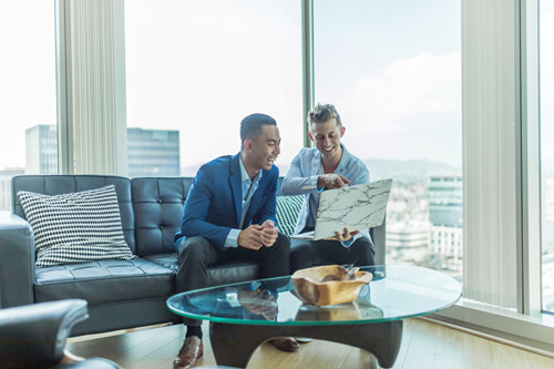 businessmen discussing strategy on laptop