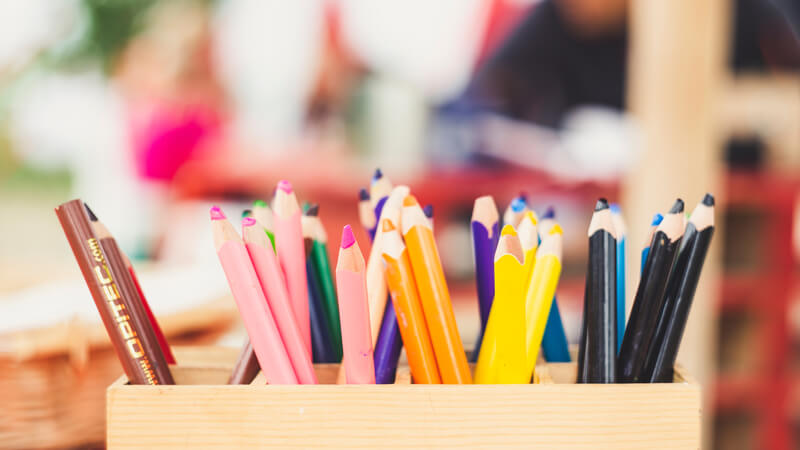 colorful pencils in a wooden box