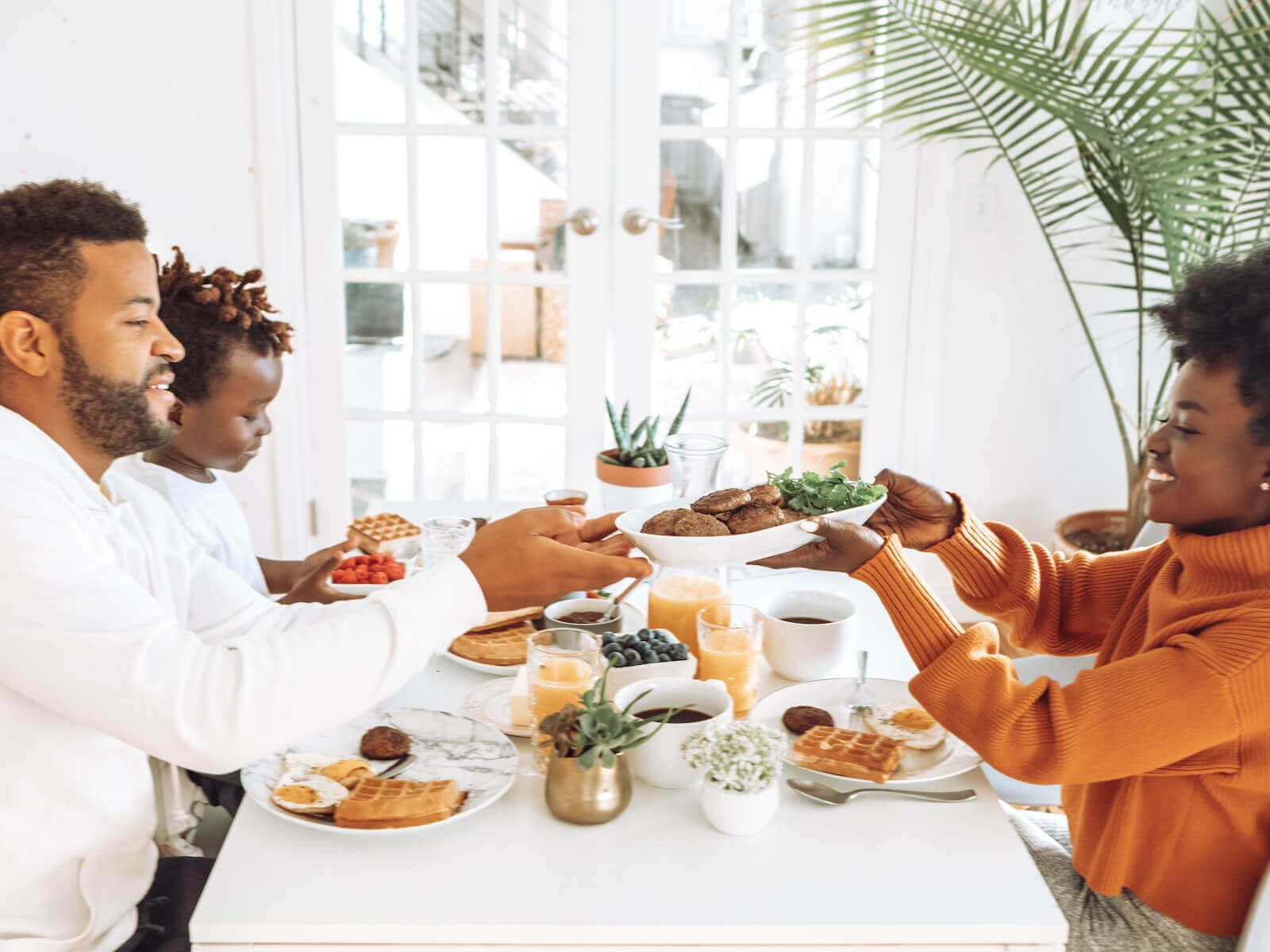smiling family sharing breakfast together